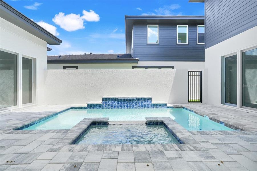 Exterior details and patio area of a home in Hampton Green at Providence, Davenport (Image 40).