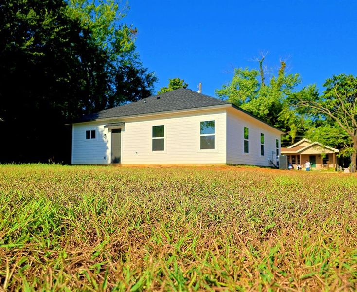 Back of house with a lawn Back of house with a lawn