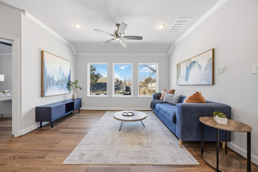 Leisure Loft: Discover a radiant game room, bathed in light, with the perfect blend of leisure and productivity just steps away in the adjacent study.