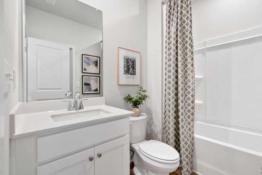 A bathroom with a shower curtain. A bathroom with a shower curtain.