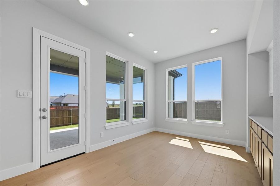 Unfurnished dining area featuring light wood finished floors and recessed lighting