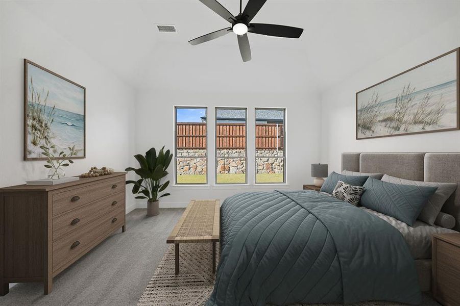 Carpeted bedroom with a ceiling fan and vaulted ceiling
