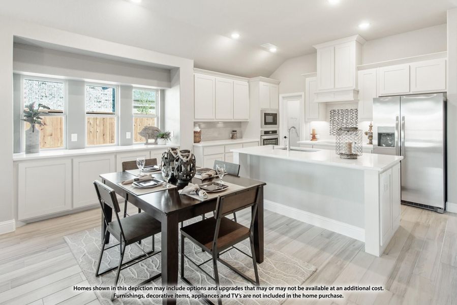 Open kitchen and dining area with white cabinets, large island, stainless appliances, and dark wood dining table.