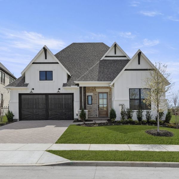 Front exterior of a new home in Mustang Lakes, Celina, TX, highlighting curb appeal (Image 29). Front exterior of a new home in Mustang Lakes, Celina, TX, highlighting curb appeal (Image 29).