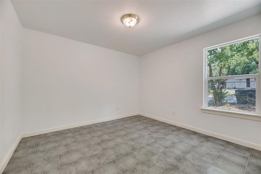 Empty room with light tile patterned floors