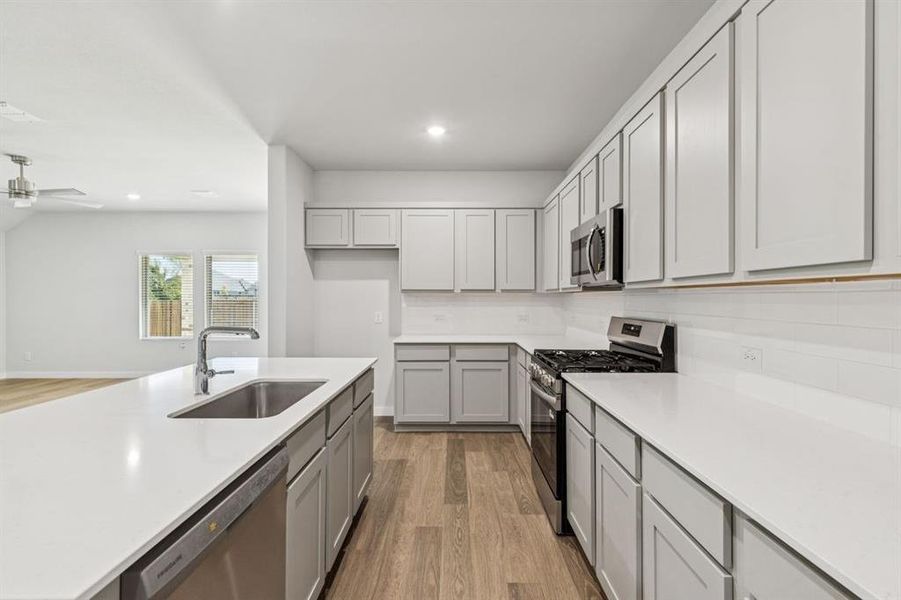 Kitchen in the Oscar home plan by Trophy Signature Homes – REPRESENTATIVE PHOTO