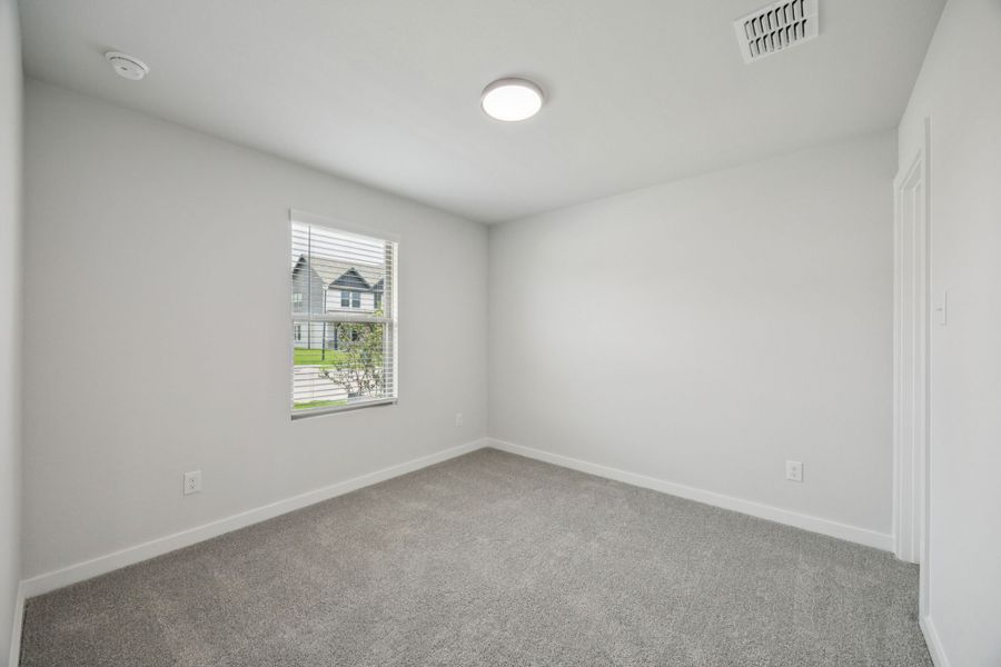 Bedroom in the Hadley home plan by Trophy Signature Homes – REPRESENTATIVE PHOTO