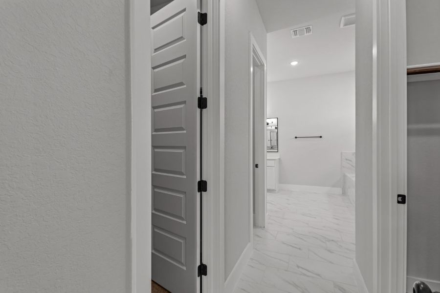 A hallway with white doors.