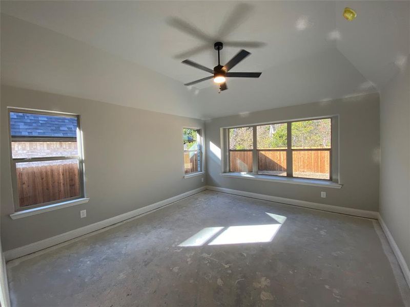 Master bedroom offers vaulted ceiling, lots of windows, and ceiling fan (greige carpet not installed yet) Master bedroom offers vaulted ceiling, lots of windows, and ceiling fan (greige carpet not installed yet)