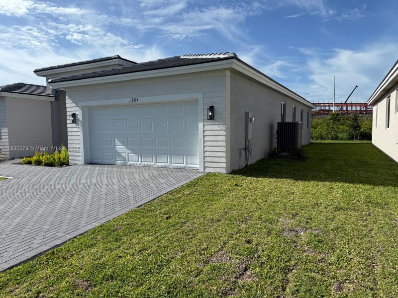 Front exterior of a new home in , Homestead, FL, highlighting curb appeal (Image 2). Front exterior of a new home in , Homestead, FL, highlighting curb appeal (Image 2).