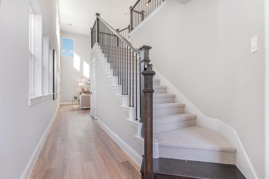 Staircase featuring hardwood / wood-style floors