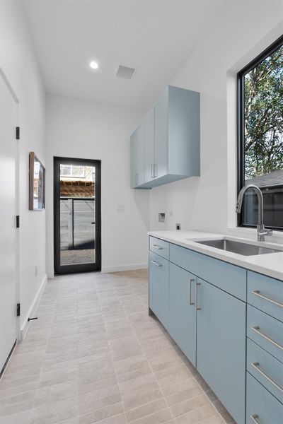 Laundry room with access to the garage as well as out to the side yard