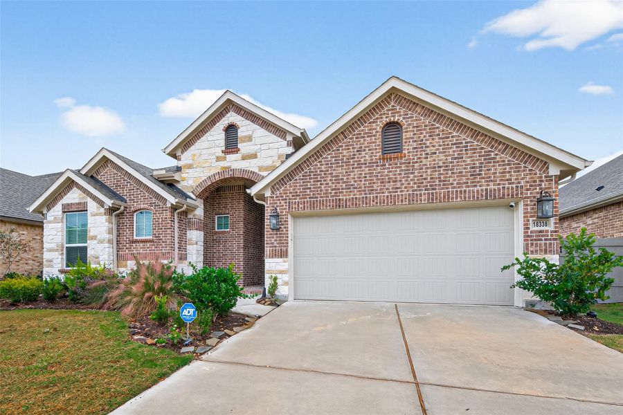 Front exterior of a new home in Artavia, Conroe, TX, highlighting curb appeal (Image 23).