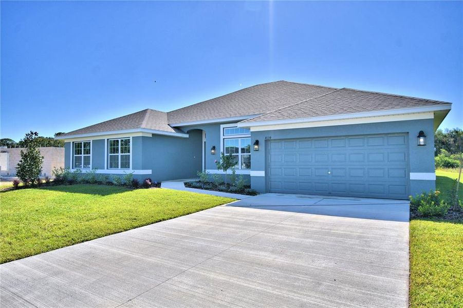 Front exterior of a new home in Cadence Crossing, Auburndale, FL, highlighting curb appeal (Image 2). Front exterior of a new home in Cadence Crossing, Auburndale, FL, highlighting curb appeal (Image 2).