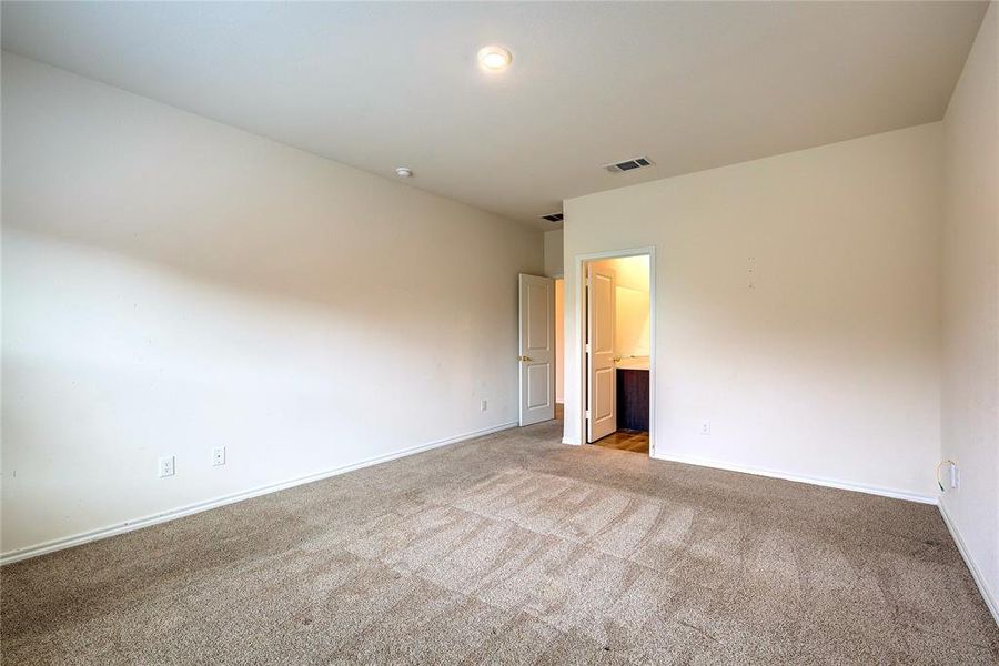 Empty room featuring carpet and baseboards