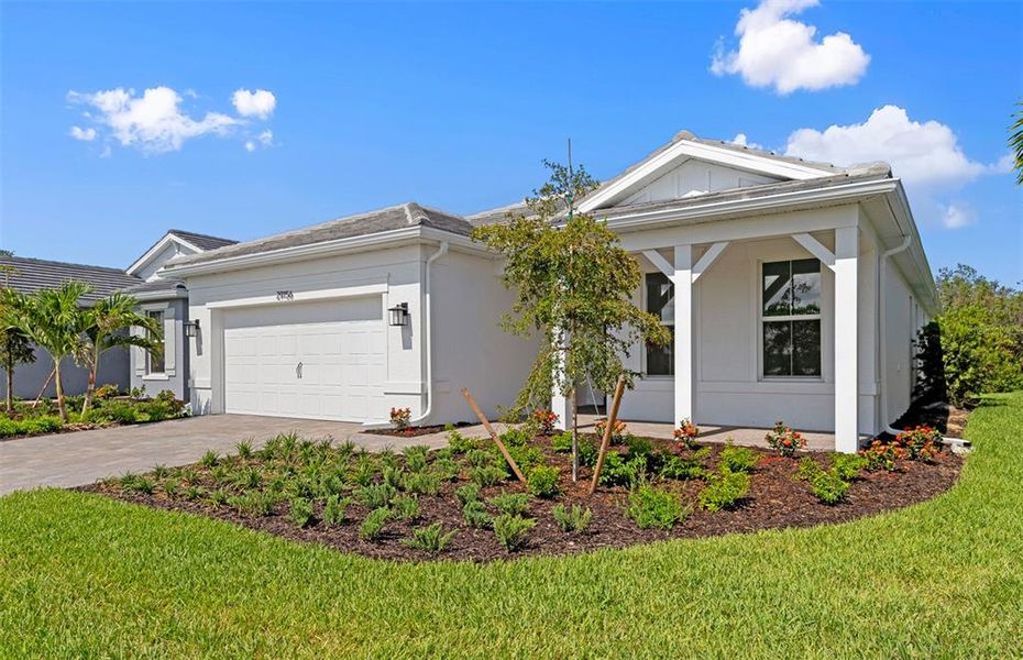 Front exterior of a new home in BeachWalk by Manasota Key, Englewood, FL, highlighting curb appeal (Image 2). Front exterior of a new home in BeachWalk by Manasota Key, Englewood, FL, highlighting curb appeal (Image 2).