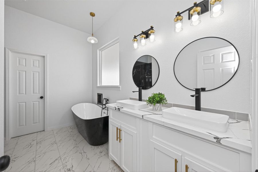 Luxurious ensuite bathroom featuring a soaking tub, walk-in shower, and double-sink vanity.