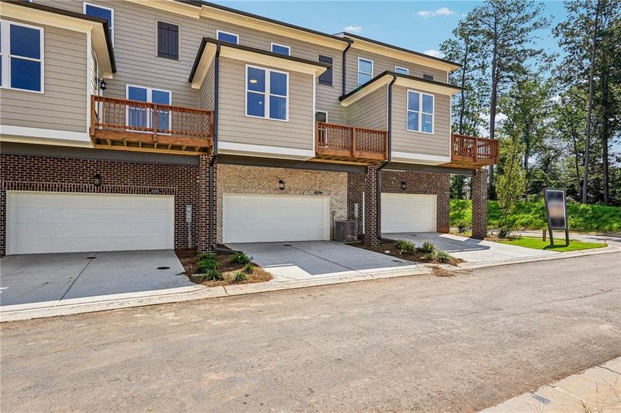 Front exterior of a new home in Waterside Townhomes, Peachtree Corners, GA, highlighting curb appeal (Image 1). Front exterior of a new home in Waterside Townhomes, Peachtree Corners, GA, highlighting curb appeal (Image 1).