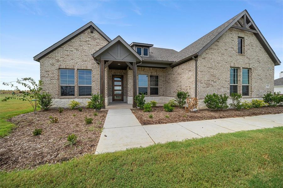 View of front of home featuring a front yard, brick siding, and roof with shingles View of front of home featuring a front yard, brick siding, and roof with shingles