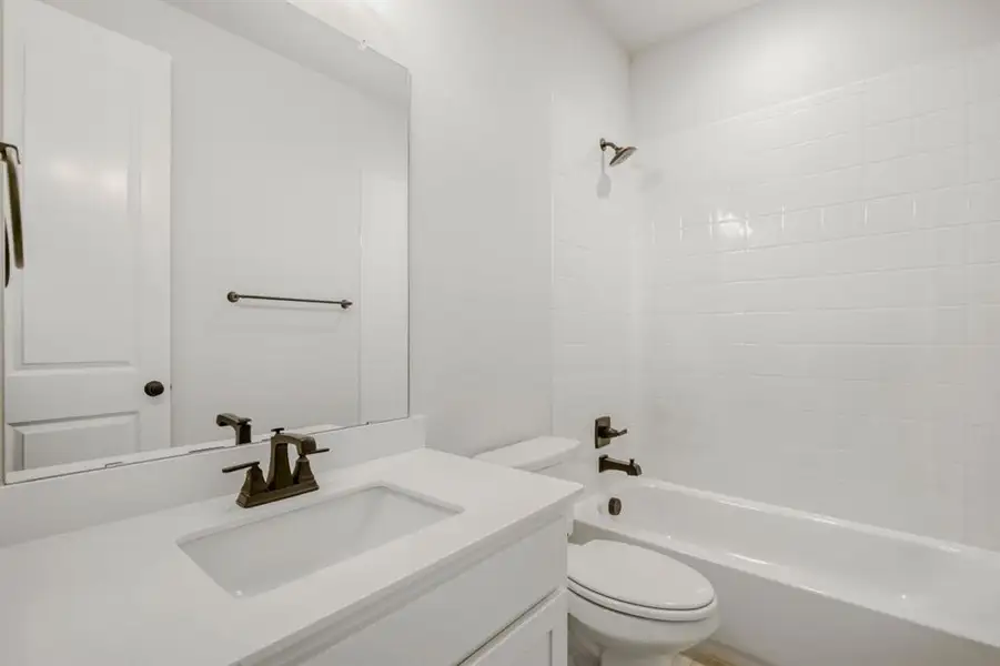 Full bath featuring vanity and shower / bath combination