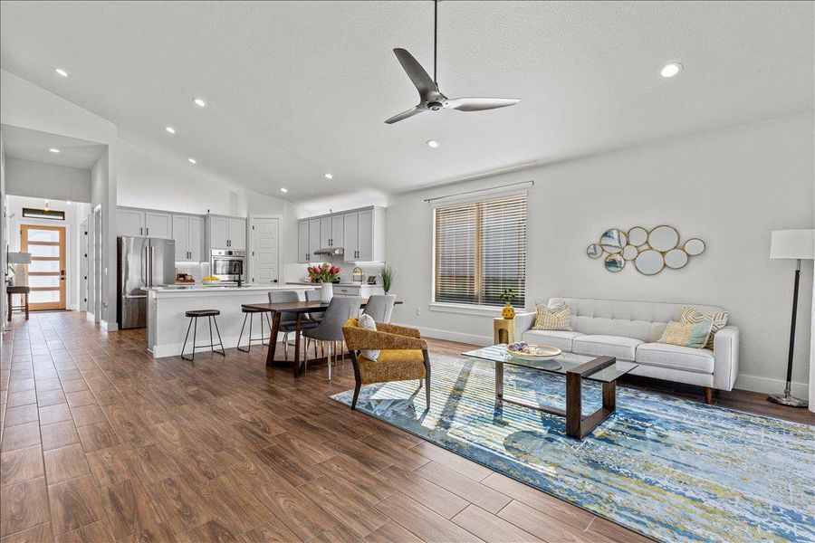 Living area featuring dark wood finished floors, recessed lighting, a ceiling fan, and vaulted ceiling