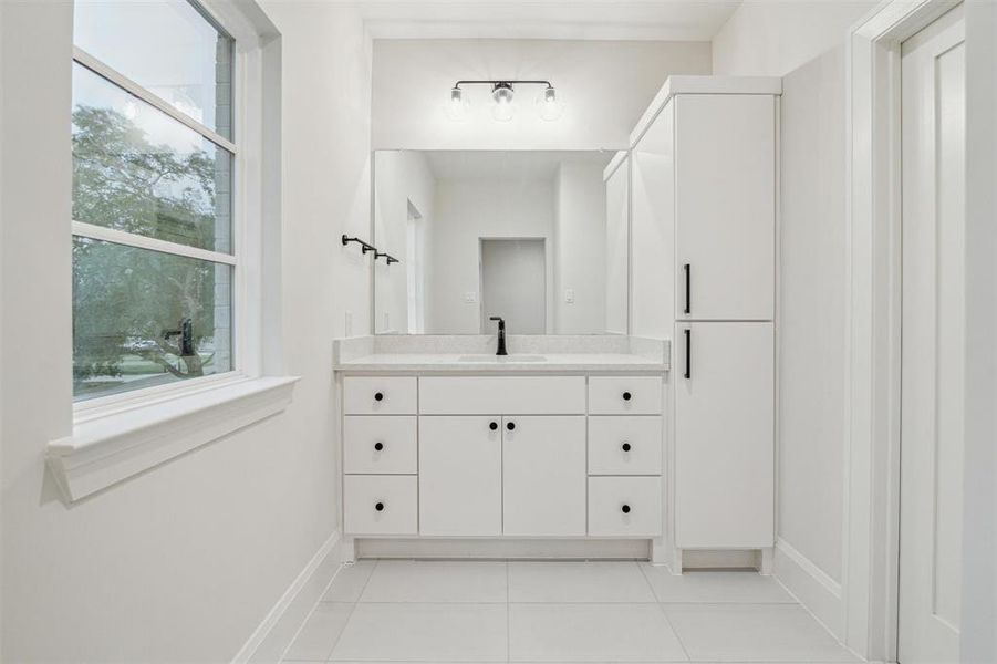 Two of the secondary bedroom share a jack and jill bath with separate vanity areas