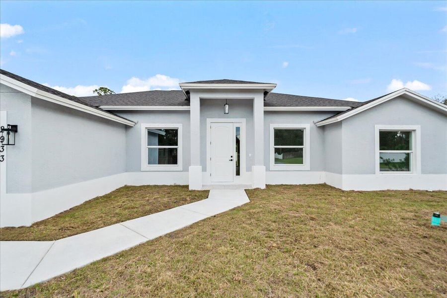 Front exterior of a new home in , Palm Bay, FL, highlighting curb appeal (Image 13). Front exterior of a new home in , Palm Bay, FL, highlighting curb appeal (Image 13).