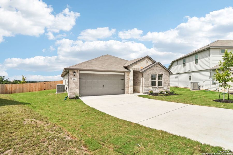 Front exterior of a new home in Legendary Trails - Classic Series, Cibolo, TX, highlighting curb appeal (Image 17).