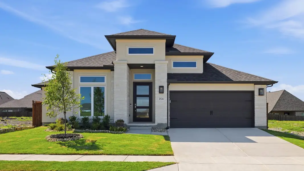 Front exterior of a new home in Devonshire, Forney, TX, highlighting curb appeal (Image 1). Front exterior of a new home in Devonshire, Forney, TX, highlighting curb appeal (Image 1).