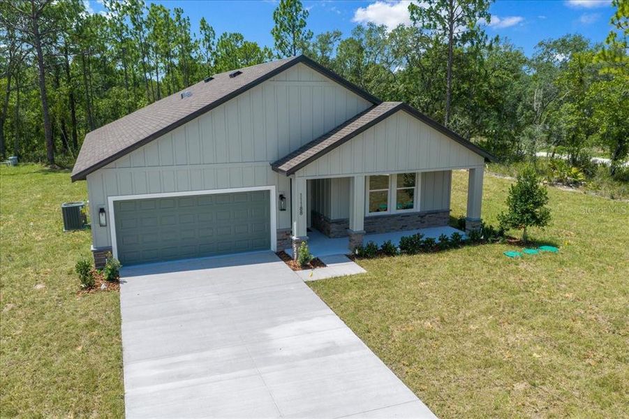 Front exterior of a new home in , Weeki Wachee, FL, highlighting curb appeal (Image 34). Front exterior of a new home in , Weeki Wachee, FL, highlighting curb appeal (Image 34).