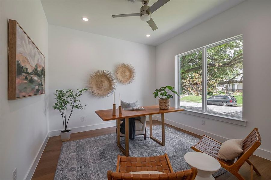 Office area with wood-type flooring and ceiling fan