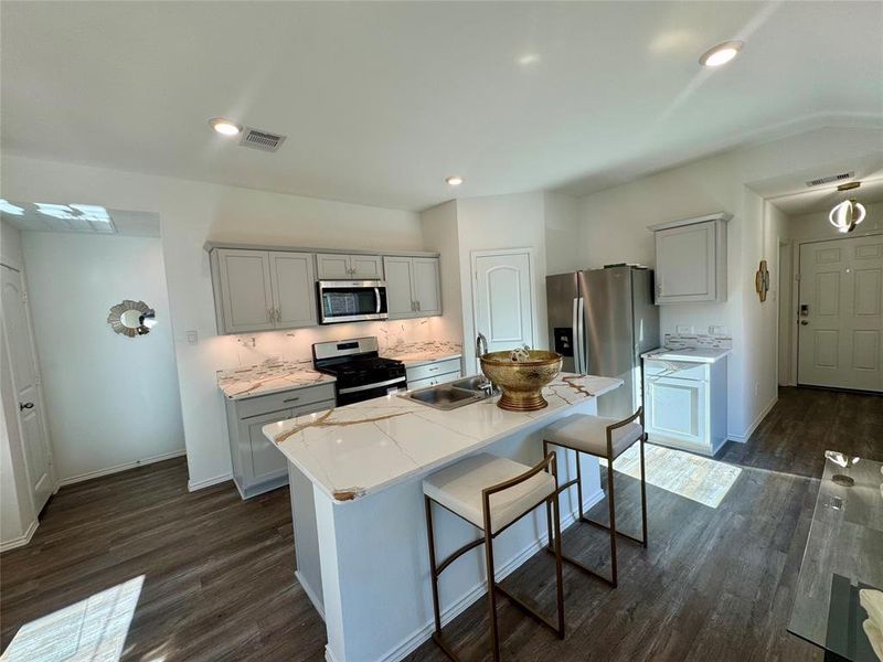 Stunning kitchen with flat maple cabinetry and crown molding,  2 Tone cabinet and drawer pull hardware