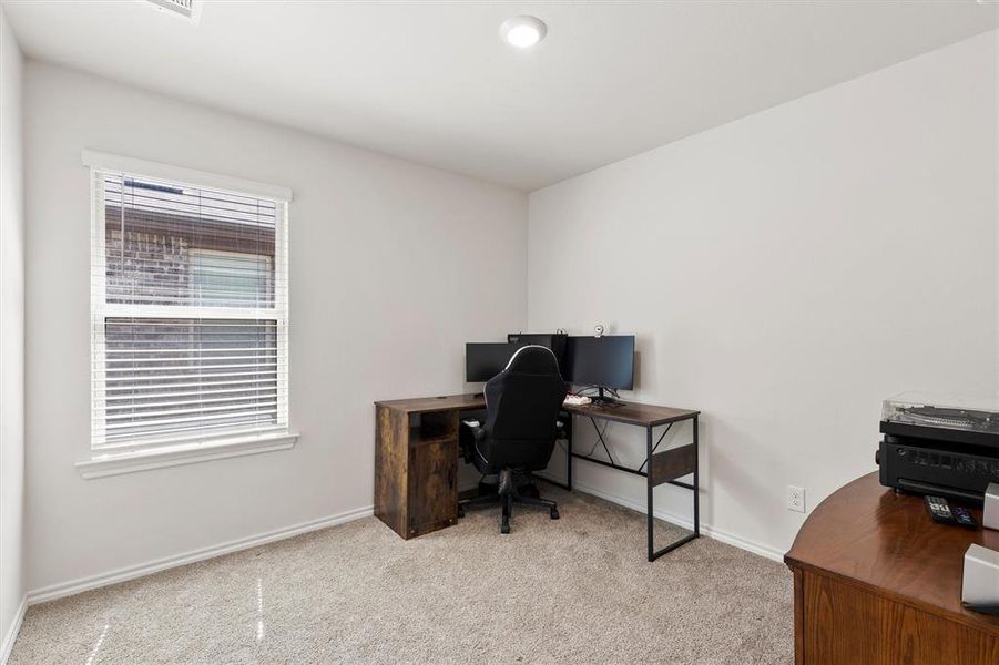Office with light colored carpet and baseboards Office with light colored carpet and baseboards