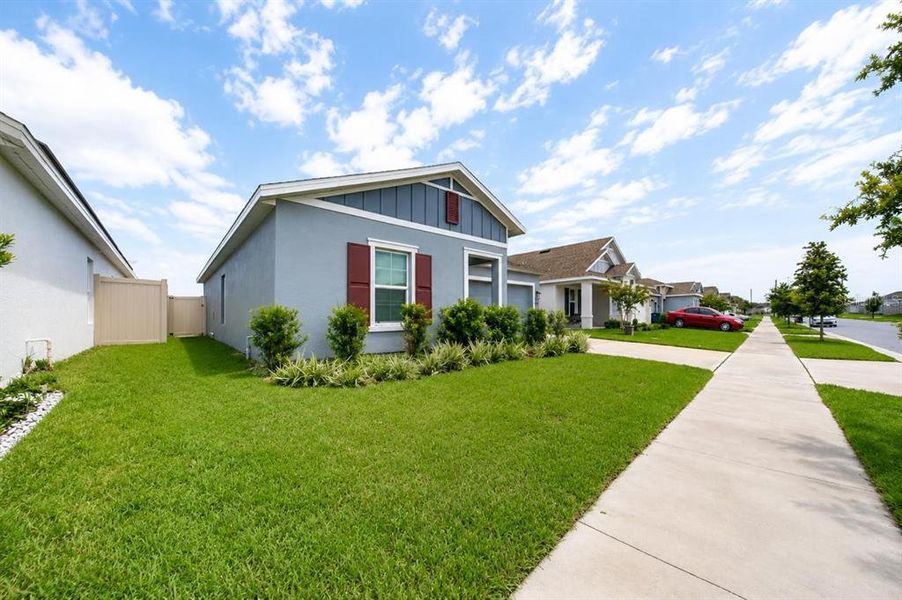Front exterior of a new home in Lawson Dunes, Haines City, FL, highlighting curb appeal (Image 14). Front exterior of a new home in Lawson Dunes, Haines City, FL, highlighting curb appeal (Image 14).
