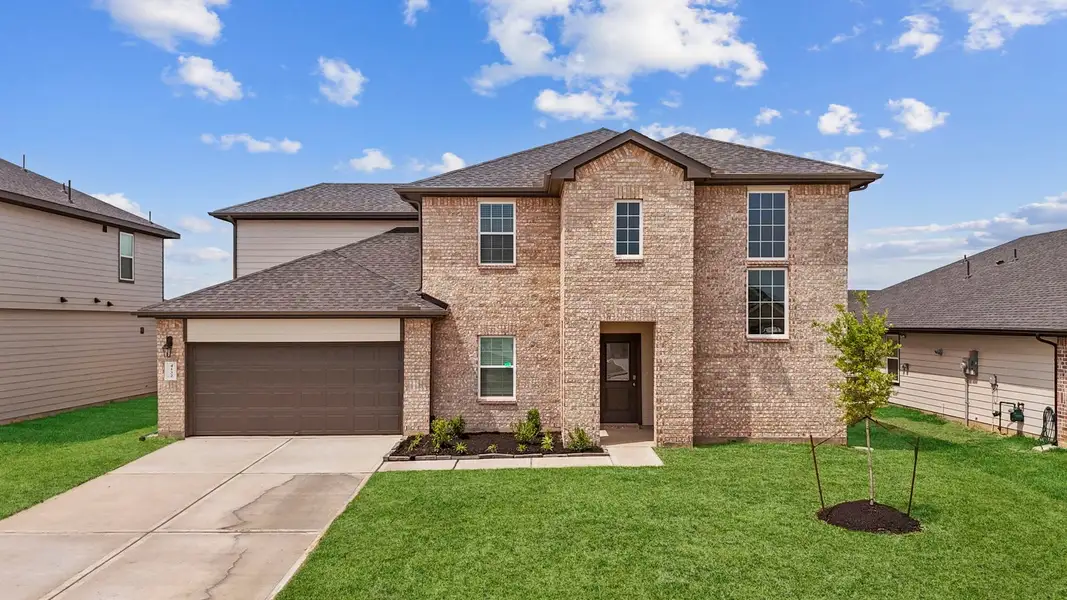 Front exterior of a new home in Tamarron, Fulshear, TX, highlighting curb appeal (Image 1). Front exterior of a new home in Tamarron, Fulshear, TX, highlighting curb appeal (Image 1).