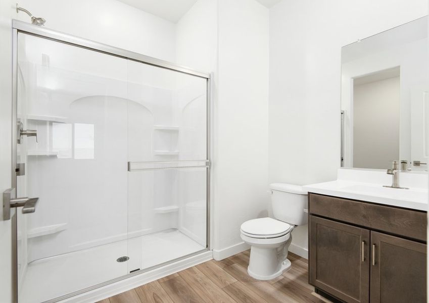 The master bathroom has a spacious glass-enclosed shower.