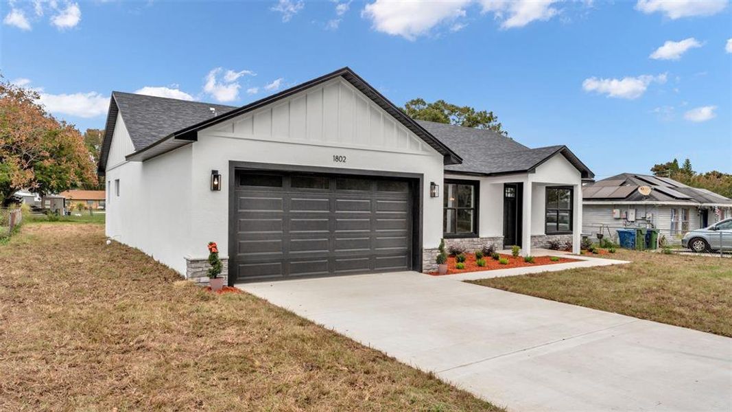 Front exterior of a new home in , Winter Haven, FL, highlighting curb appeal (Image 22). Front exterior of a new home in , Winter Haven, FL, highlighting curb appeal (Image 22).