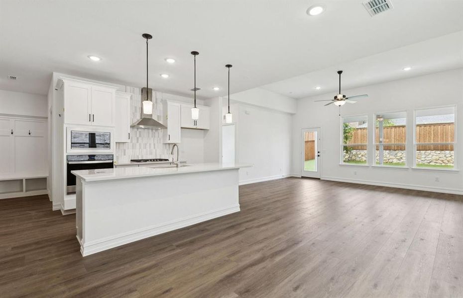 Spacious eat-in kitchen designed with a large island for dining   *Real home pictured