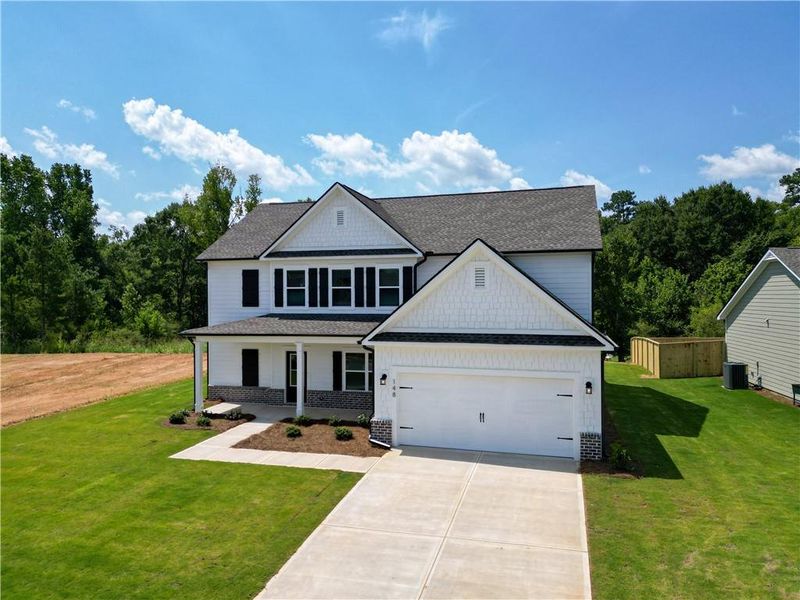 Front exterior of a new home in Harmony Farms, Eatonton, GA, highlighting curb appeal (Image 29).