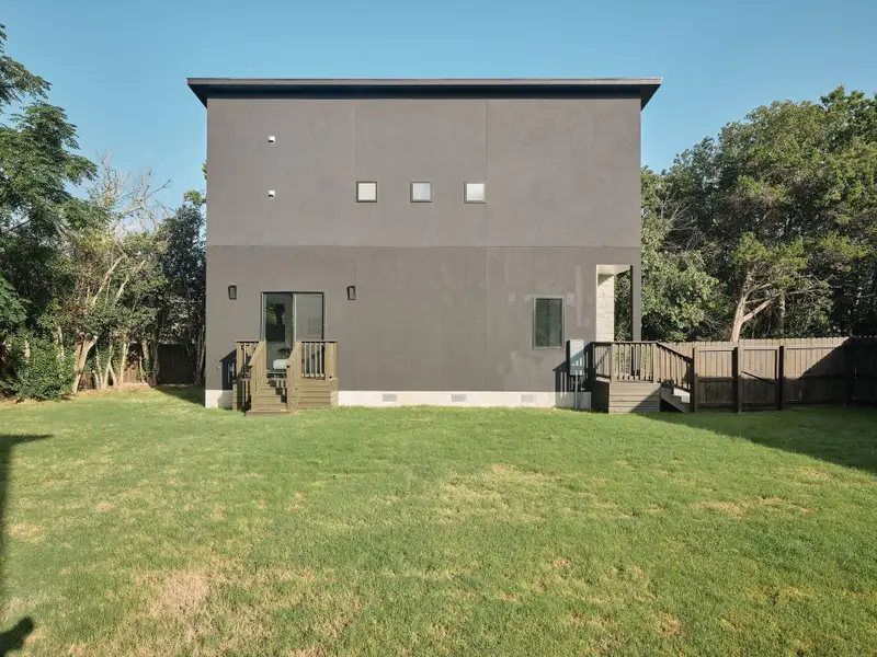 Rear view of house featuring crawl space and stucco siding