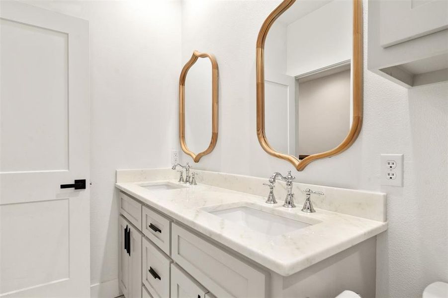 Bathroom with double vanity and toilet