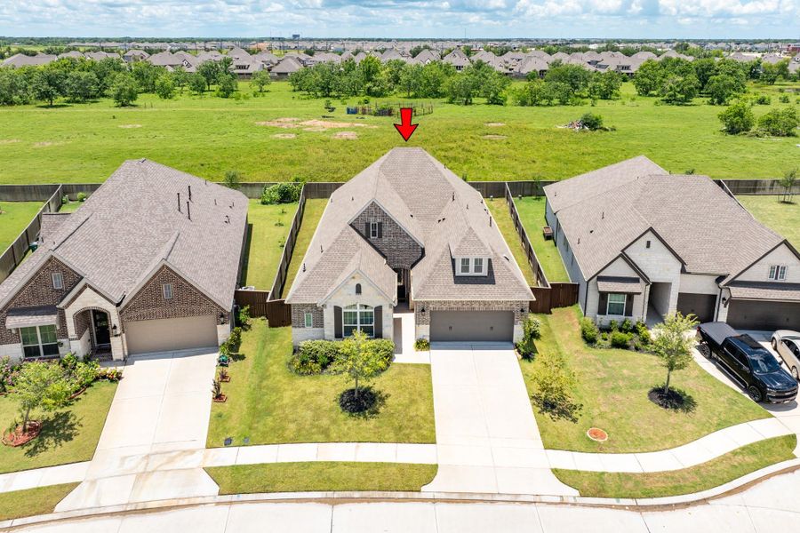 The exterior of this home shows that there are no houses behind it, so the backyard will be peaceful and quiet. The aerial shot shows no one close behind, which creates a calming effect, especially for those looking for a safe and quiet neighborhood.