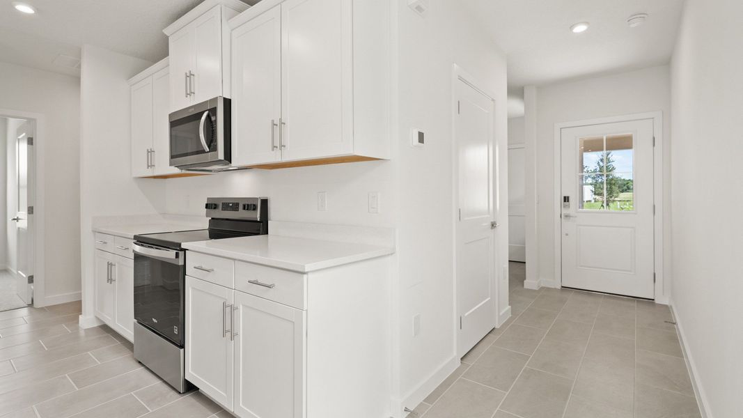 The Flagler Floorplan at Grasslands West new home in Lakeland, FL Showcasing a bright Kitchen & Entryway.