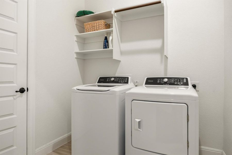 Washroom featuring baseboards and washer and clothes dryer