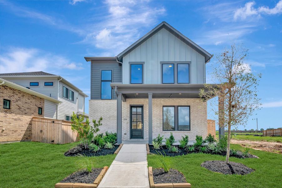 Front exterior of a new home in Sienna - Landmark Row Collection, Missouri City, TX, highlighting curb appeal (Image 2). Front exterior of a new home in Sienna - Landmark Row Collection, Missouri City, TX, highlighting curb appeal (Image 2).