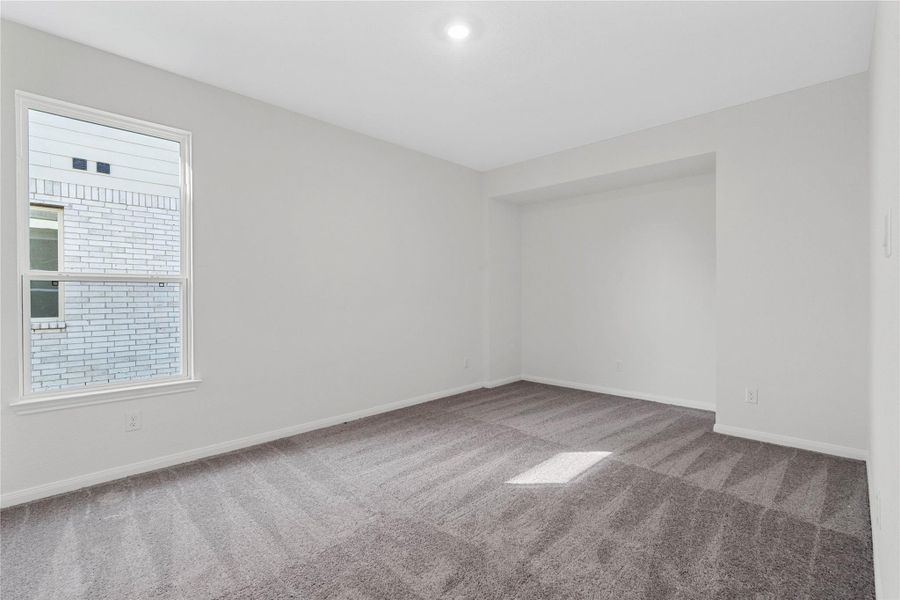 This spacious Den offers a versatile space that seamlessly expands your living options—perfect for a home office, playroom, media space, or whatever suits your lifestyle. Featuring plush carpeting, neutral toned paint, recessed lighting, large window and a nook, perfect for an entertainment center or shelving!