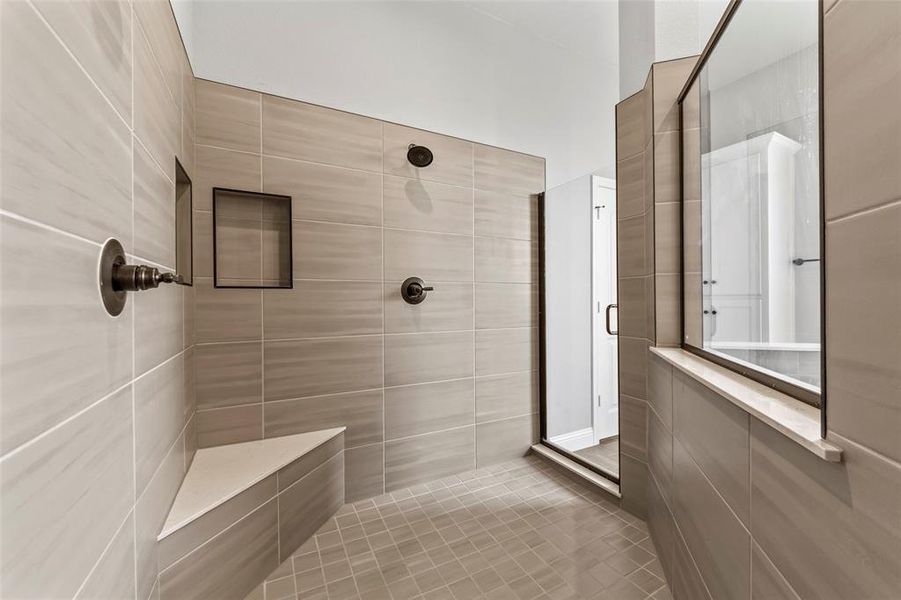 Bathroom with a tile shower and tile patterned floors