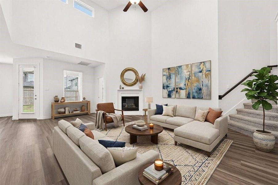 Family Room: The family room impresses with soaring ceilings and a cozy fireplace, creating a warm and welcoming atmosphere. Virtually Staged Family Room: The family room impresses with soaring ceilings and a cozy fireplace, creating a warm and welcoming atmosphere. Virtually Staged