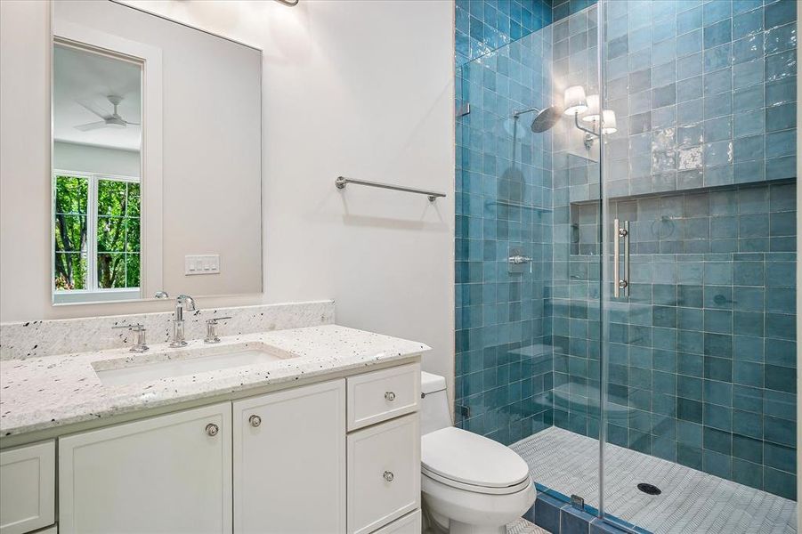 Bath, blue glazed tile shower, single vanity, frameless glass enclosure Bath, blue glazed tile shower, single vanity, frameless glass enclosure