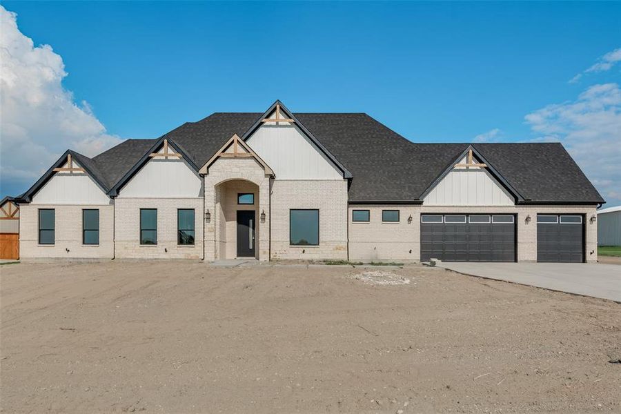 View of front facade featuring a garage